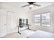 Bright bedroom with ceiling fan, desk, window view, and double door closet at 1023 S Sea Bridge Ct., Surfside Beach, SC 29575