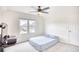 Bright bedroom with window, ceiling fan, white walls, carpeted floors, with simple bed frame at 1023 S Sea Bridge Ct., Surfside Beach, SC 29575