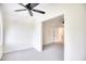 Neutral-toned bedroom featuring a ceiling fan, carpet, and doorway leading to another room with closet at 1023 S Sea Bridge Ct., Surfside Beach, SC 29575