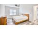 Bedroom with wood bed frame, wood-look floors and a view into the bathroom at 1023 S Sea Bridge Ct., Surfside Beach, SC 29575