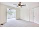 Spacious, carpeted bedroom with ceiling fan, closet, and arched window leading to another room at 1023 S Sea Bridge Ct., Surfside Beach, SC 29575