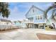 Charming stilted beach house with blue siding, white trim, and a spacious driveway and under house parking at 1023 S Sea Bridge Ct., Surfside Beach, SC 29575
