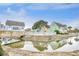 Exterior view featuring a waterfront property with a pool, bridge, and colorful beach homes at 1023 S Sea Bridge Ct., Surfside Beach, SC 29575