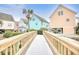 Charming exterior view featuring a bridge, gazebo, and colorful beach homes at 1023 S Sea Bridge Ct., Surfside Beach, SC 29575