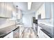 Well-lit kitchen with white cabinetry, stainless steel appliances, granite counters, and modern finishes at 1023 S Sea Bridge Ct., Surfside Beach, SC 29575