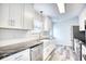 Bright kitchen with white cabinetry, stainless steel appliances, and gray countertops at 1023 S Sea Bridge Ct., Surfside Beach, SC 29575