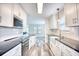 Modern kitchen featuring white cabinets, subway tile backsplash, and stainless steel appliances at 1023 S Sea Bridge Ct., Surfside Beach, SC 29575