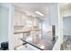 Bright kitchen with white cabinets, granite countertops, stainless steel appliances, and modern fixtures at 1023 S Sea Bridge Ct., Surfside Beach, SC 29575