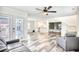 Open-concept living room featuring wood-look flooring, a ceiling fan, and a comfortable sofa at 1023 S Sea Bridge Ct., Surfside Beach, SC 29575