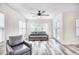 Bright living room featuring a ceiling fan, comfortable sofa, and a door to the outside at 1023 S Sea Bridge Ct., Surfside Beach, SC 29575