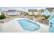 Community pool area with lounge chairs and nearby bridge leading to homes at 1023 S Sea Bridge Ct., Surfside Beach, SC 29575