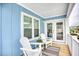Inviting covered porch with comfortable seating, white railings, and view to the street at 1023 S Sea Bridge Ct., Surfside Beach, SC 29575