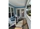 Inviting covered porch with comfortable seating, white railings, and views of the surrounding neighborhood at 1023 S Sea Bridge Ct., Surfside Beach, SC 29575