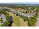 Beautiful aerial view of condo complex with golf course views, pond, and surrounding greenery at 1025 World Tour Blvd. # 301, Myrtle Beach, SC 29579