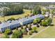 Scenic aerial view of condo buildings nestled in a golf course and neighborhood with mature trees at 1025 World Tour Blvd. # 301, Myrtle Beach, SC 29579