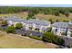 Aerial view of condo complex with parking and lush landscaping, offering a serene living environment at 1025 World Tour Blvd. # 301, Myrtle Beach, SC 29579