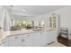 Open concept kitchen with white cabinetry, light countertops, and view to the living area at 1025 World Tour Blvd. # 301, Myrtle Beach, SC 29579