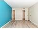 Bright bedroom with aqua accent wall, durable vinyl flooring, and ample closet space at 10301 North Kings Hwy. # 13-5, Myrtle Beach, SC 29572