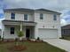 Charming two-story home with a manicured lawn and a two-car garage, offering classic curb appeal at 1038 Laconic Dr., Myrtle Beach, SC 29588