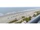 Scenic beach view with colorful umbrellas and lush green landscaping at 1105 South Ocean Blvd. # 1008, Myrtle Beach, SC 29577