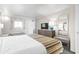 Bright bedroom featuring a queen bed, neutral colors, dresser with TV, and well-lit space at 1105 South Ocean Blvd. # 1008, Myrtle Beach, SC 29577