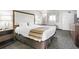 Queen bed with white and beige bedding, bedside table, window with curtains, and neutral decor at 1105 South Ocean Blvd. # 1008, Myrtle Beach, SC 29577