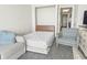 Bedroom featuring a sofa bed and a comfortable armchair with a view to the hallway at 1105 South Ocean Blvd. # 1008, Myrtle Beach, SC 29577