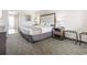 This bedroom has a queen bed, nightstand with lamp, luggage rack and neutral decor at 1105 South Ocean Blvd. # 1008, Myrtle Beach, SC 29577