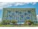 Exterior view of a multi-story condo building with multiple balconies and lush landscaping at 1105 South Ocean Blvd. # 1008, Myrtle Beach, SC 29577