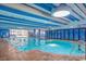 Large indoor pool with comfortable lighting and adjacent seating area, great for relaxation at 1105 South Ocean Blvd. # 1008, Myrtle Beach, SC 29577