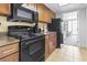 Efficiency kitchen with a stove, microwave, cabinets, and a view into dining area at 1105 South Ocean Blvd. # 1008, Myrtle Beach, SC 29577