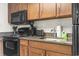Well-equipped kitchen with sleek appliances, including a microwave, stove, and a cozy breakfast nook at 1105 South Ocean Blvd. # 1008, Myrtle Beach, SC 29577