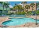 An outdoor pool area featuring a wading pool, several palm trees, and lounge chairs at 1105 South Ocean Blvd. # 1008, Myrtle Beach, SC 29577
