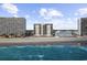 Oceanfront condo buildings along the beach, with blue water and partly cloudy skies at 1108 N Waccamaw Dr. # C-4, Garden City Beach, SC 29576