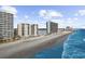 Stunning aerial view of beachfront condos along a beautiful beach with blue ocean waters at 1108 N Waccamaw Dr. # C-4, Garden City Beach, SC 29576