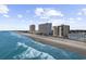Picturesque aerial of oceanfront condos along a scenic beach with blue ocean water and clear skies at 1108 N Waccamaw Dr. # C-4, Garden City Beach, SC 29576