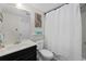 Well-lit bathroom with a sink, toilet, and shower with a curtain at 1108 N Waccamaw Dr. # C-4, Garden City Beach, SC 29576
