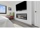 Comfortable bedroom with a fireplace, TV, white walls and ensuite bathroom at 1108 N Waccamaw Dr. # C-4, Garden City Beach, SC 29576