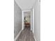 Hallway with gray brick accent wall, leading to a room with coastal decor at 1108 N Waccamaw Dr. # C-4, Garden City Beach, SC 29576