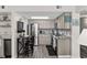 Bright kitchen with modern appliances, light cabinets, and a dining area at 1108 N Waccamaw Dr. # C-4, Garden City Beach, SC 29576