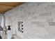 Close-up of the kitchen's white marble backsplash, accented by a unique black and white checkered outlet cover at 1108 N Waccamaw Dr. # C-4, Garden City Beach, SC 29576