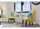 Bright sitting area featuring comfortable yellow chairs and ocean views from the window at 1108 N Waccamaw Dr. # C-4, Garden City Beach, SC 29576