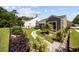Landscaped backyard with stone pathway, patio, and neatly trimmed shrubs at 1129 Prescott Circle, Myrtle Beach, SC 29577