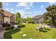 Charming backyard featuring lush green grass, landscaping, and a cozy patio seating area for outdoor relaxation at 1129 Prescott Circle, Myrtle Beach, SC 29577