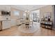 Bright dining area features a modern chandelier, wainscoting, and lots of natural light from two windows at 1129 Prescott Circle, Myrtle Beach, SC 29577
