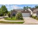 Charming single-story home with a well-manicured lawn, attached garage, and beautiful landscaping at 1129 Prescott Circle, Myrtle Beach, SC 29577