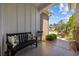 Inviting front porch with a bench, decorative pillows, potted plants, and a charming garden at 1129 Prescott Circle, Myrtle Beach, SC 29577