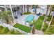 Aerial view of a home's backyard pool and patio area, surrounded by lush landscaping and palm trees at 113 B Vista Dr., Murrells Inlet, SC 29576