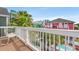 Balcony with a partial view of an inground pool surrounded by palm trees with building views in the distance at 113 B Vista Dr., Murrells Inlet, SC 29576