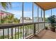 Enclosed balcony featuring neighborhood and swimming pool views, a table and large potted plant at 113 B Vista Dr., Murrells Inlet, SC 29576